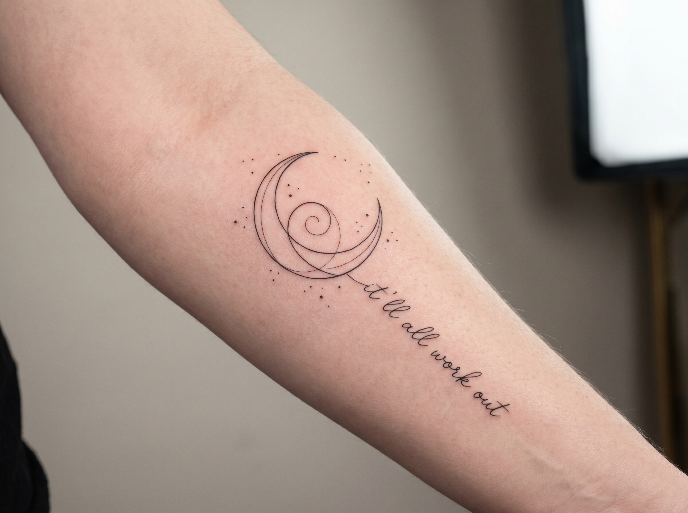 Crescent moon tattoo on forearm